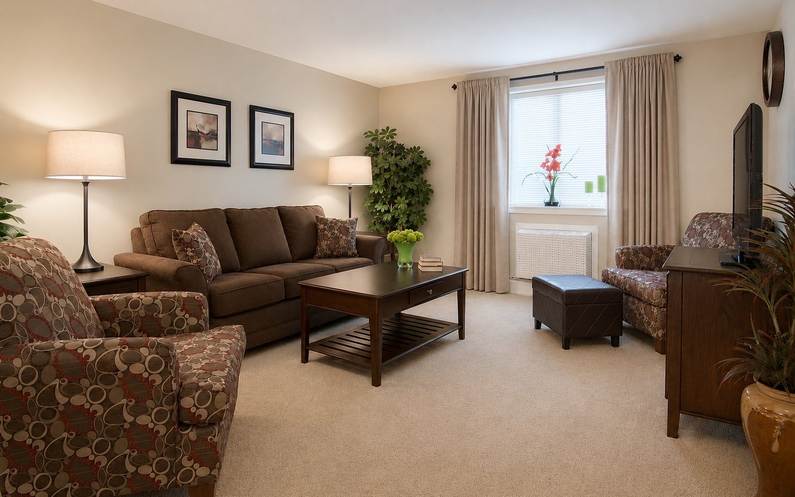 Furnished living room in a J.E. apartment with sofa, armchairs and coffee table