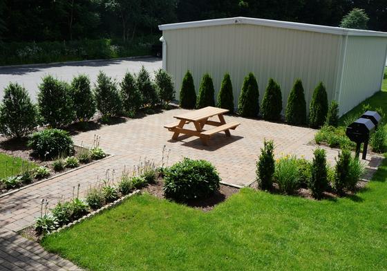 Patio, lawn and plantings at J.E. Quincy