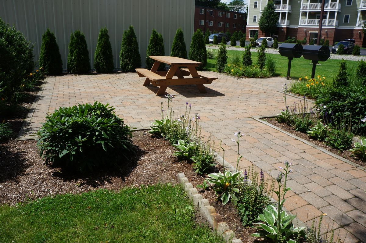 Landscaped courtyard with seating at a J.E. Furnished Apartments property