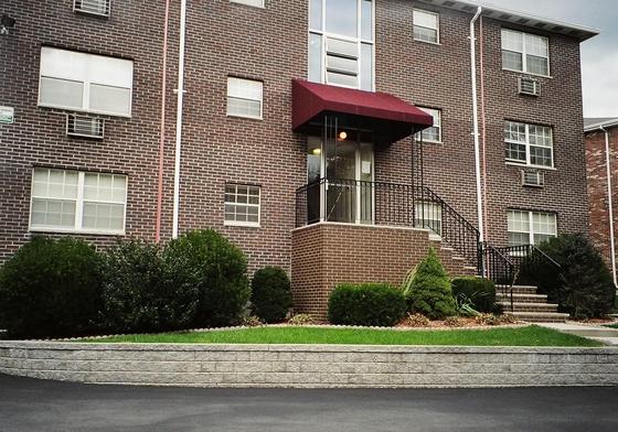 Rear of the J.E. apartment building at 310 College Farm Road, Waltham