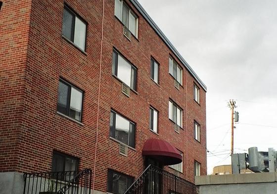 Rear of the J.E. apartment building at 345 Lincoln Street, Waltham