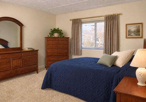 Furnished bedroom with navy bedding at 345 Lincoln Street, Waltham