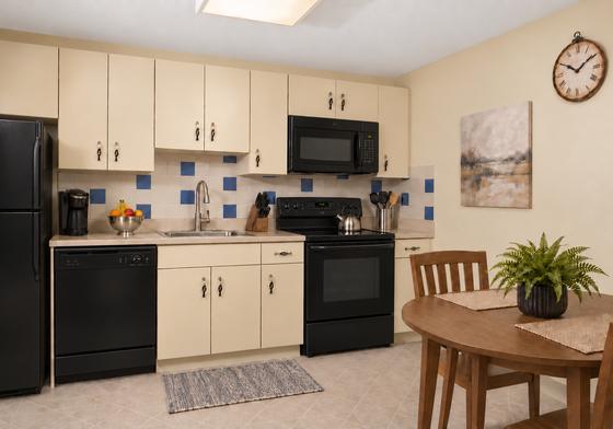 Kitchen with black appliances at 345 and 330 Lincoln Street, Waltham